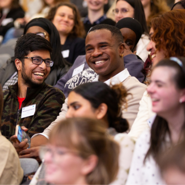 A lecture theatre full of smiling UCD students.